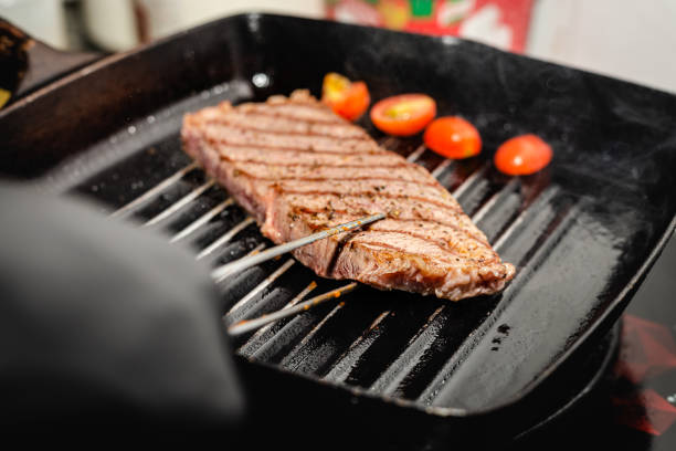 Close up wagyu beef striploin steak with pepper on dark panhokubeephotography