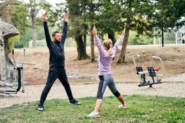 istock Fitness couple doing stretching exercises in the park 1344610407