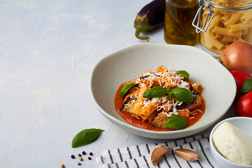 pasta alla norma with eggplant ricotta tomato sauce copy space