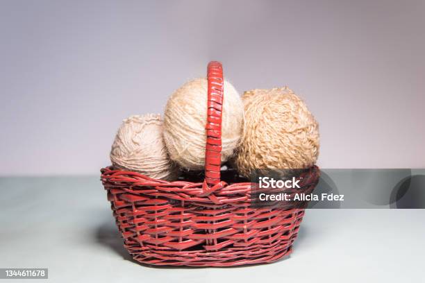 Beige Balls Of Wool Inside A Wicker Basket Stock Photo - Download Image Now - Knitting Needle, Art And Craft, Art and Craft Equipment