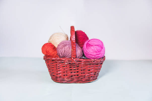 istock Pink balls of wool inside a wicker basket 1344611715