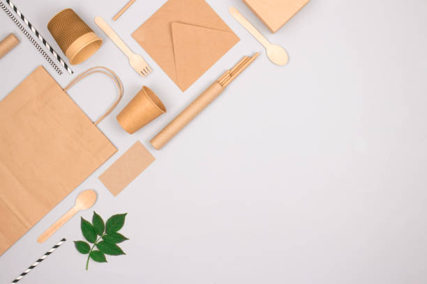 istock Eco-friendly tableware - kraft paper food packaging on light gray background with copy space. Street food paper packaging, recyclable paperware, zero waste packaging concept. Flat lay 1344613118