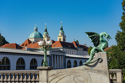 Dragon bridge in Ljubljana with dragon statue .