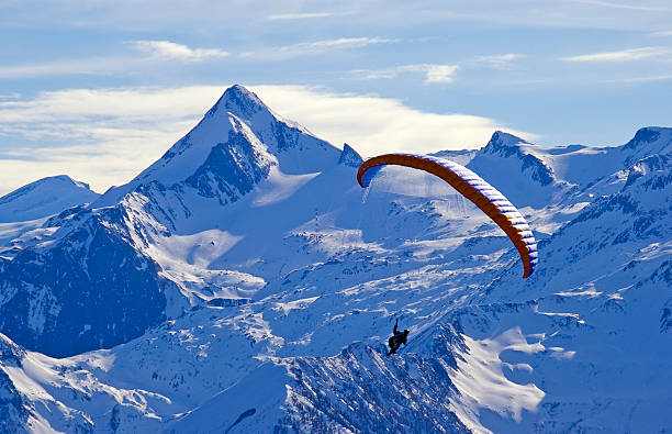 istock winter paragliding in alps mountains 134461505