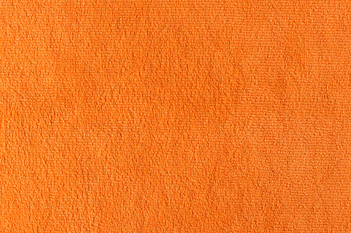 orange microfiber cloth for cleaning or dishwashing. Cleaning background texture