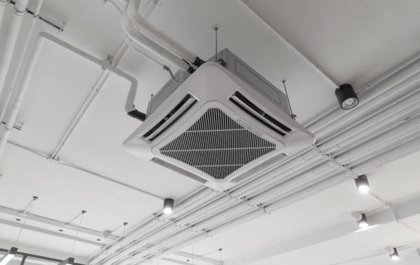 istock Modern white ceiling mounted cassette type air conditioner in office building system work. Ventilation compressor. 1344616860