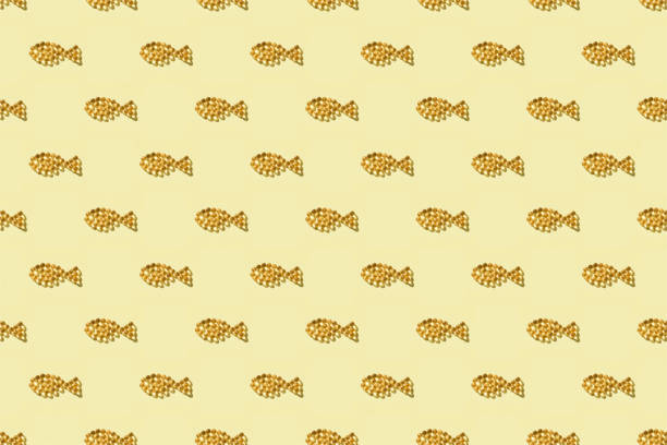 Seamless pattern from fish oil capsules in fish shape on yellow background.