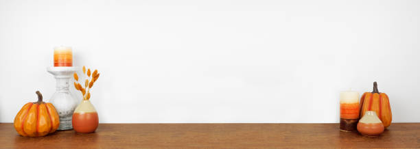 istock Autumn decor on a wood shelf against a white wall background 1344617218