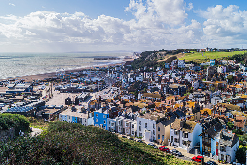 A view of Hastings Old Town taken from the East Hill. Many old houses are nestled in the Bourne Stream valley. The beach and Hastings Pier can be seen in the background