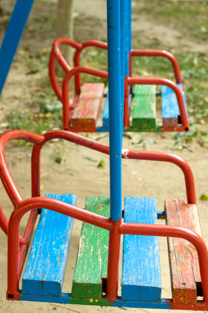istock two empty wooden swings on the playground 1344620245