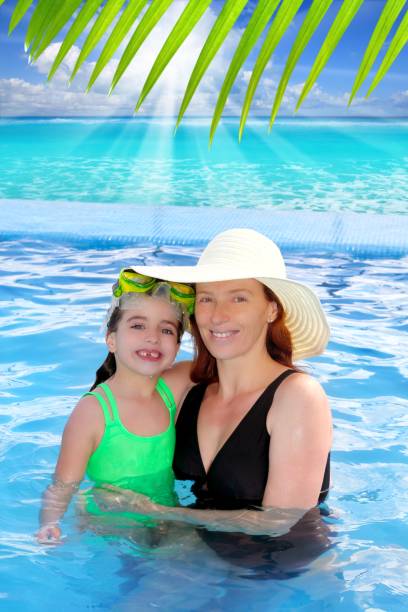 istock mother and daughter hug in pool tropical beach 1344622687