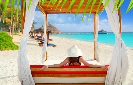 gazebo tropical beach with woman rear view looking sea from a tropical resort