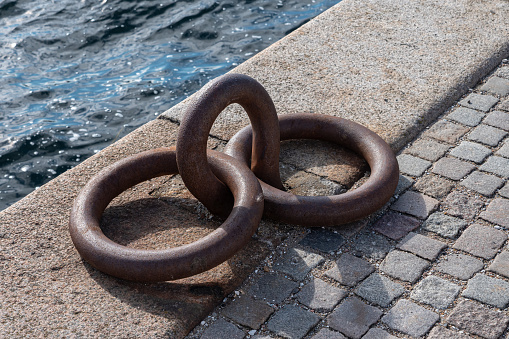 Two rusty anchor rings in the port area