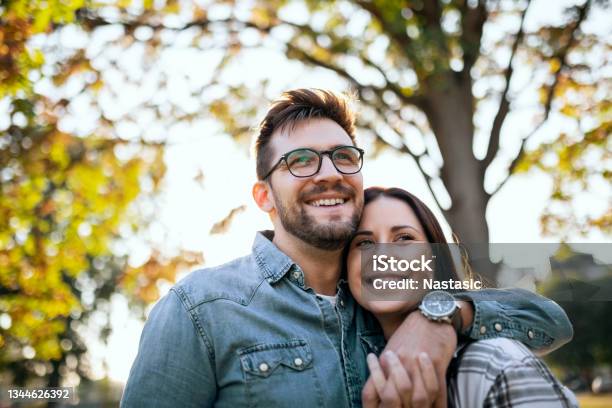 Young Couple And Autumn Sunny Day Stock Photo - Download Image Now - Couple - Relationship, Happiness, Outdoors