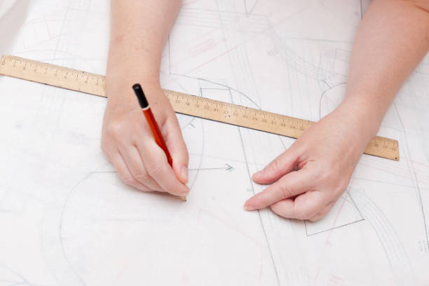 istock Female designer drawing flat paper patterns. Exclusive clothes making concept. 1344626411