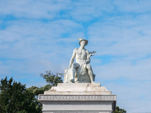 Mercury statue in Copenhagen against a blue sky with white clouds