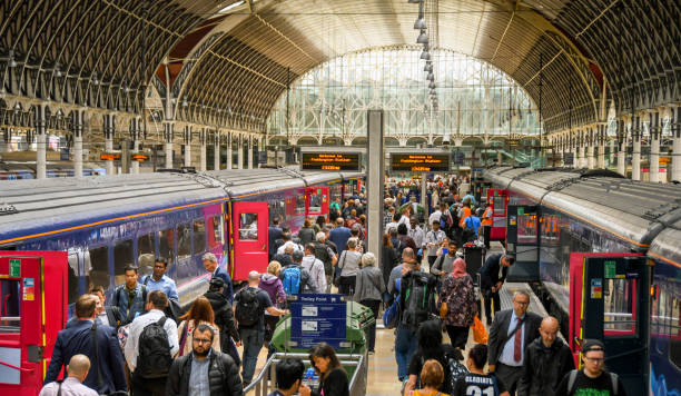 London, England - June 2018: Crowd of people on the platform after arriving at London Padington railway station.