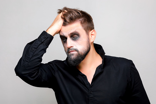 halloween and makeup for a bearded man who tears the hair on his head
