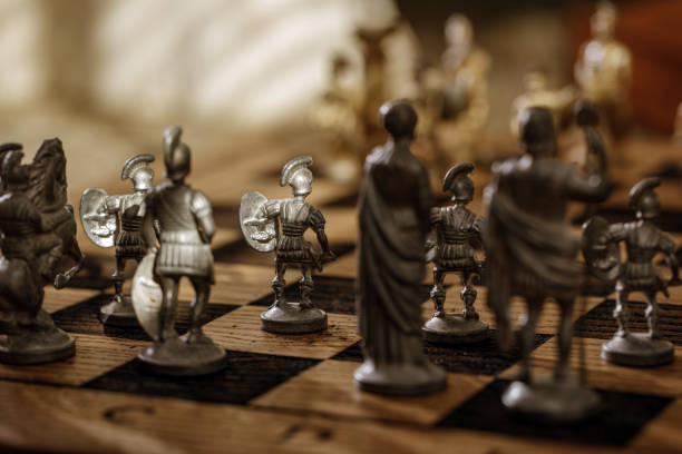 istock Ancient metal Roman Chess Set with silver and gold plated pieces on solid oak wood Board. Concept image for business strategy, competition, relaxation, recreation and mental agility. 1344631249