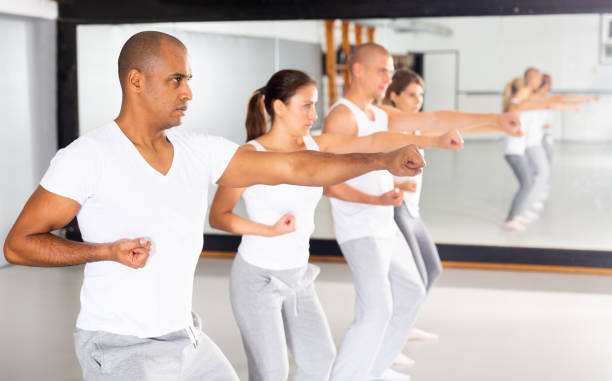 istock Men and women mastering self-defense techniques in training room 1344633796