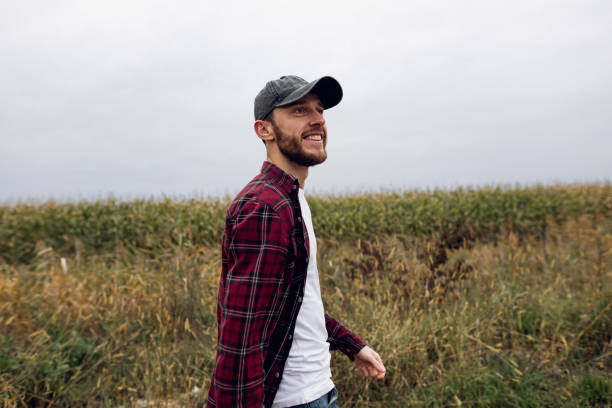 istock A young smiling millennial farmer passing by and  watching at a corn field 1344636270
