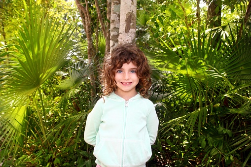 Little tourist girl posing in Mayan Riviera Jungle tree Mexico