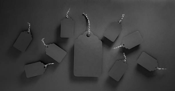 Black tags on black. Biggest one and many small. Black friday background with copy space