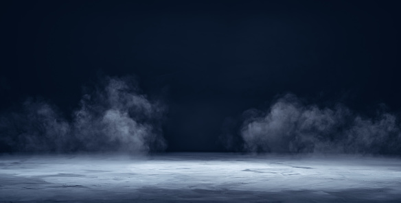 Plataforma, podio o mesa de hormigón texturizado gris con humo en la oscuridad photo