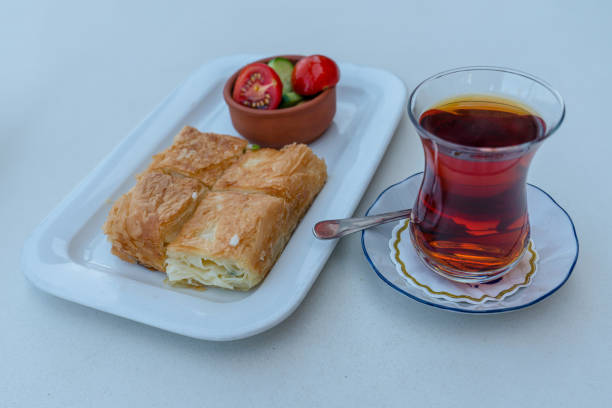 istock Traditional Turkish breakfast, tea, water pastry and tomato, cucumber. 1344637880