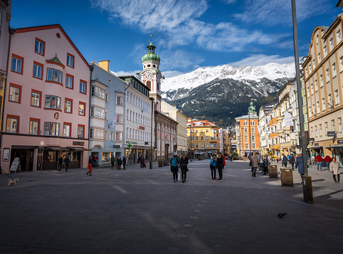 Innsbruck, Austria - Nov 14, 2019: Street view of Maria-Theresien-Strasse with Alps Mountains on background - Innsbruck, Tyrol, Austria