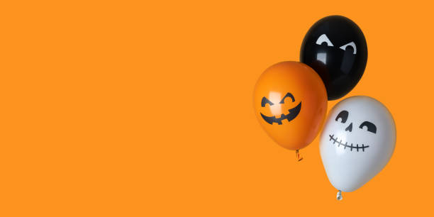 istock Orange, black and white halloween balloons on orange background 1344642693