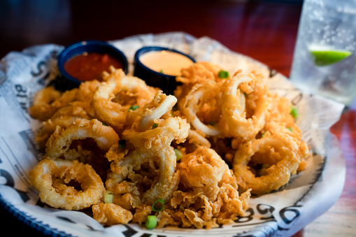 Delicious Deep Fried Rings Of Crispy Calamari Squid Served With Spicy Aioli And Marinara Sauce