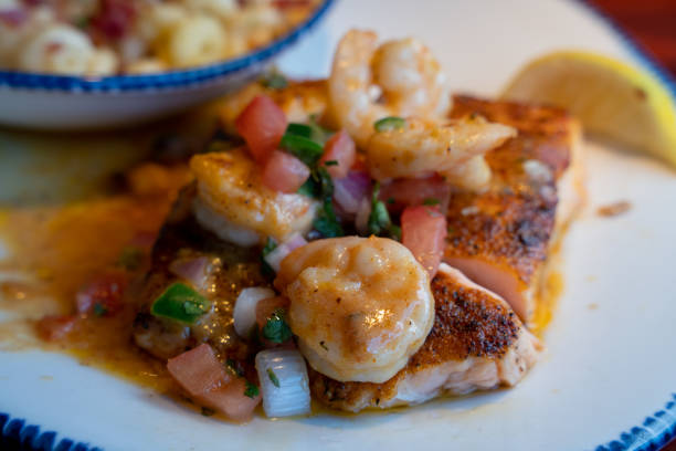 Grilled Salmon Topped, Sauteed Shrimp In A Delicious Cajun Sauce With A Side Of Three Cheese Macaroni Sprinkled With Crumbled Bacon