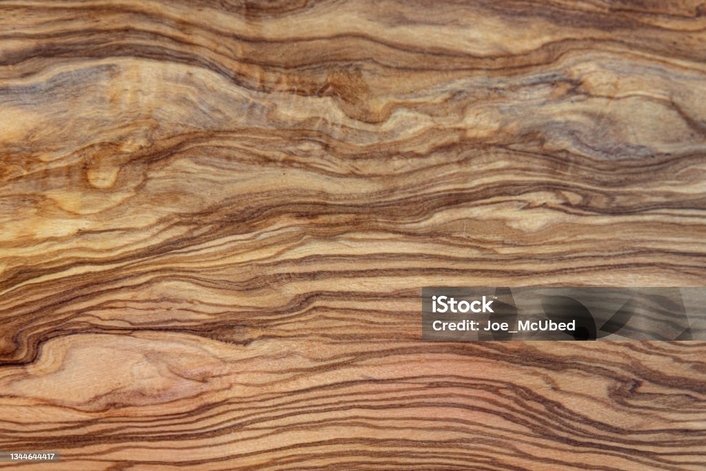 Olive tree wood background with brown betas Solid olive tree wood treated and varnished, it is a very hard wood and is highly durable Wood - Material Stock Photo