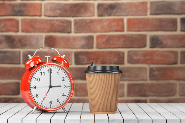 break concept, breakfast time. time to wake up. red alarm clock and paper cup on a wooden table with a brick background. 3d render. - wakening imagens e fotografias de stock