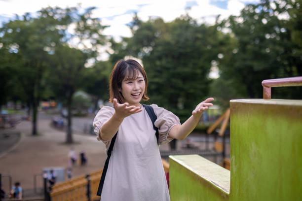 istock Mother talking to her son in public park 1344648035