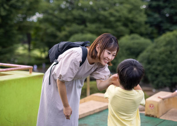 istock Mother talking to her son in  public park 1344649017