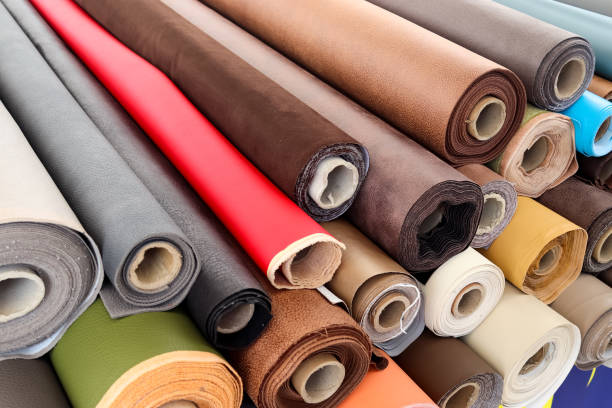 istock Close up view on rolled samples of cloth and fabrics in different colors found at a fabrics market.. 1344651241