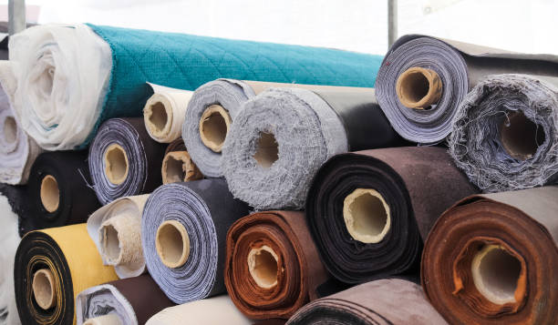 istock Close up view on rolled samples of cloth and fabrics in different colors found at a fabrics market.. 1344651278