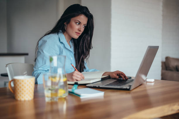 istock Businesswoman using a laptop while in her office working 1344652607