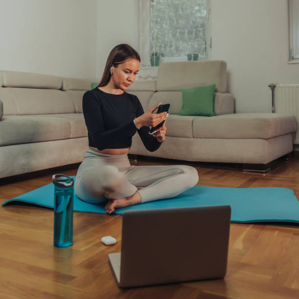 istock Young woman taking selfie with her smartphone while training at home 1344652639