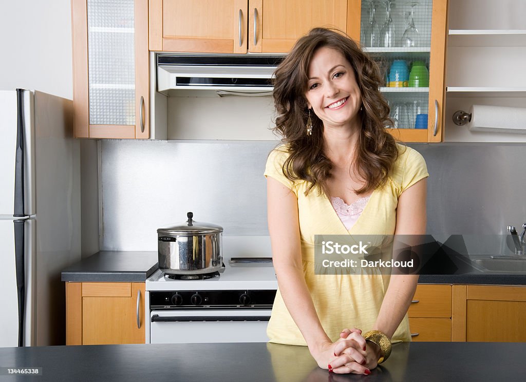 My Kitchen Woman poses in kitchen.  Adult Stock Photo