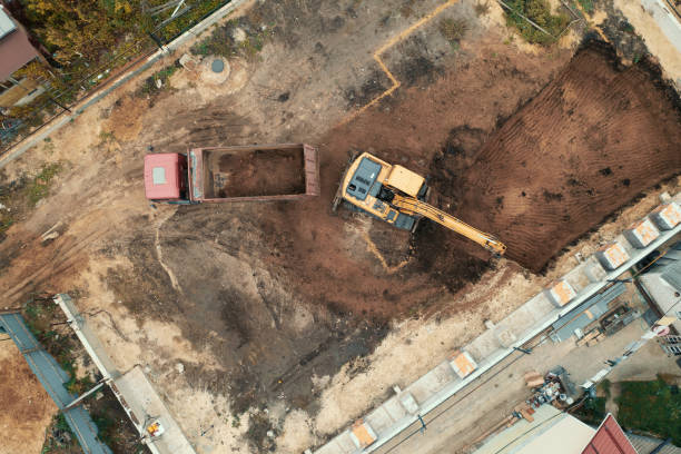 istock Digging foundation pit with excavator on construction site aerial top view 1344658760