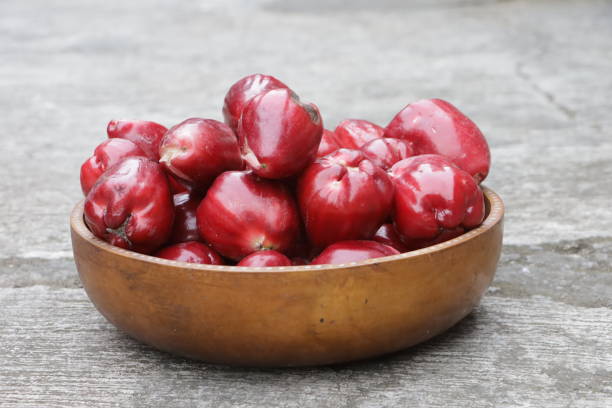 pile of water apples in a wooden bowl