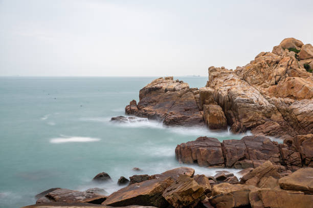 istock Rocks and waves by the sea 1344667568