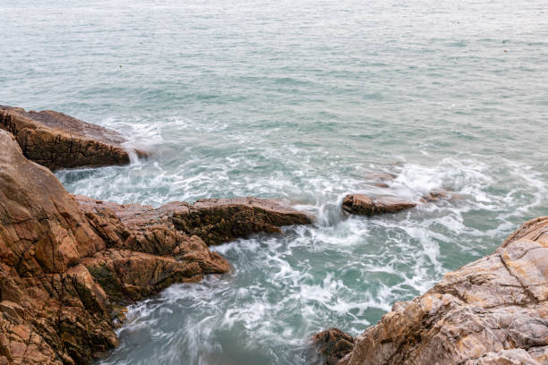 istock Rocks and waves by the sea 1344668271
