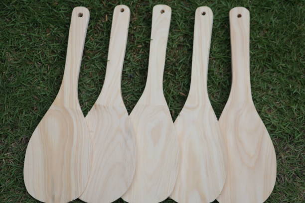 istock wooden rice spoon on green grass 1344668330