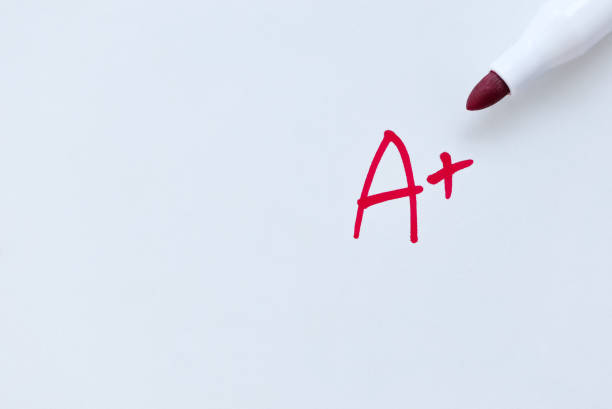 istock A plus grade written in red pen on paper. Grade Mark. 1344670023