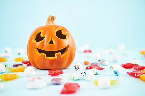 Bright Halloween Background with Smiling Jack O'Lantern and Candy