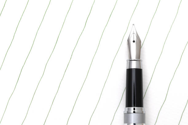 Silver ballpoint pen laying on table isolated on white